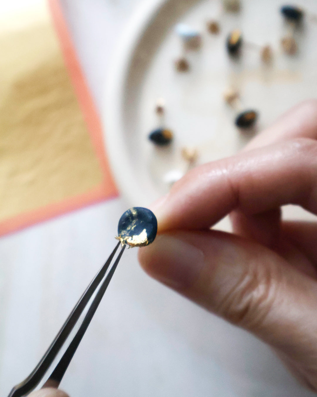 Applying gold leaf by hand