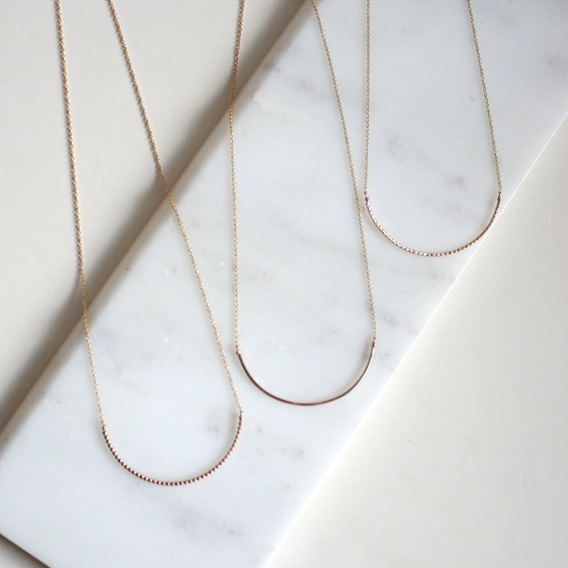 gold arc necklaces