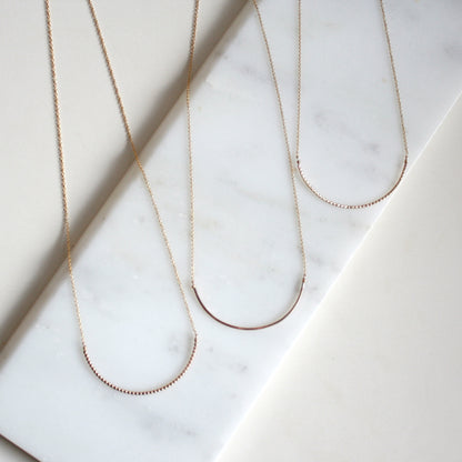 gold arc necklaces