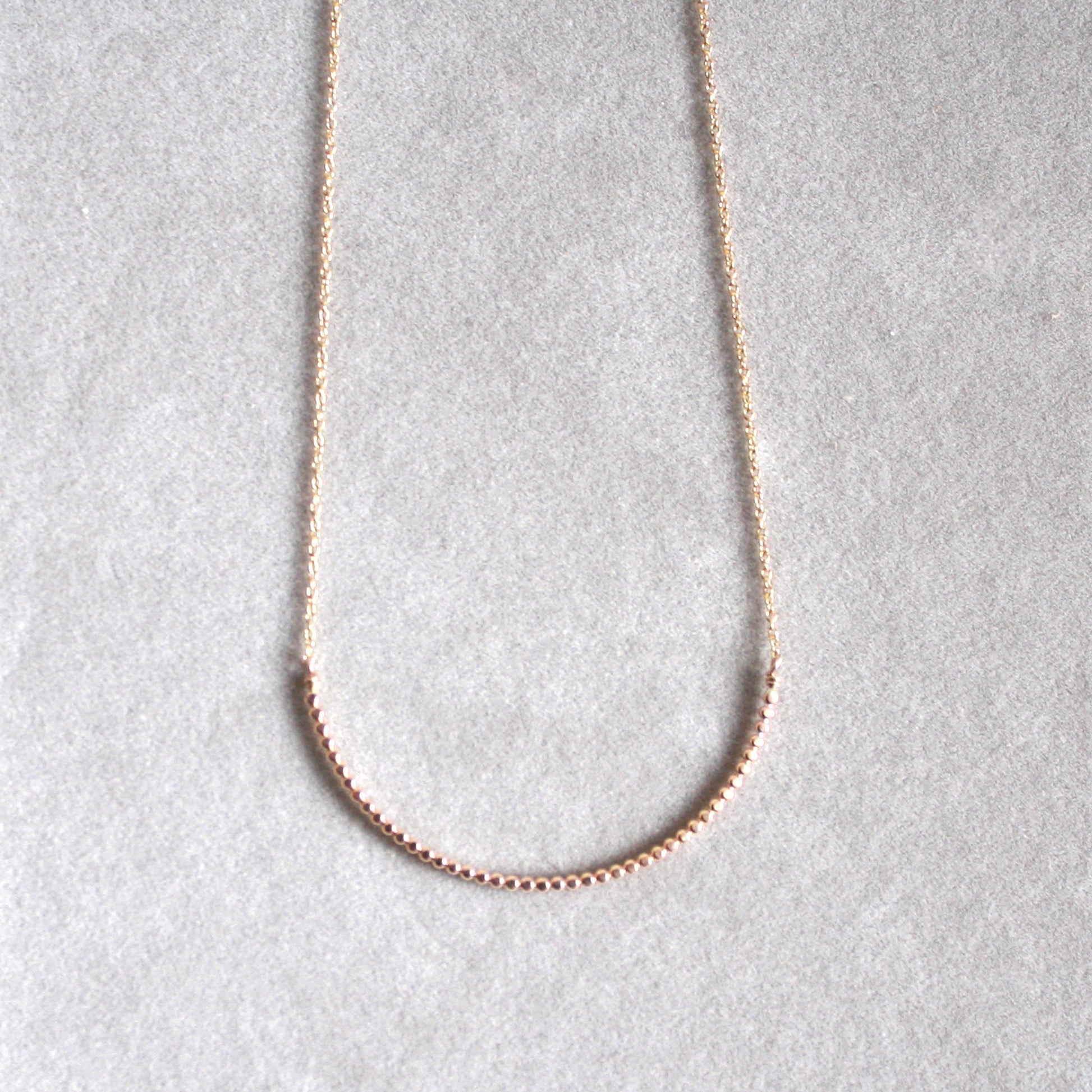 gold beaded arc necklace