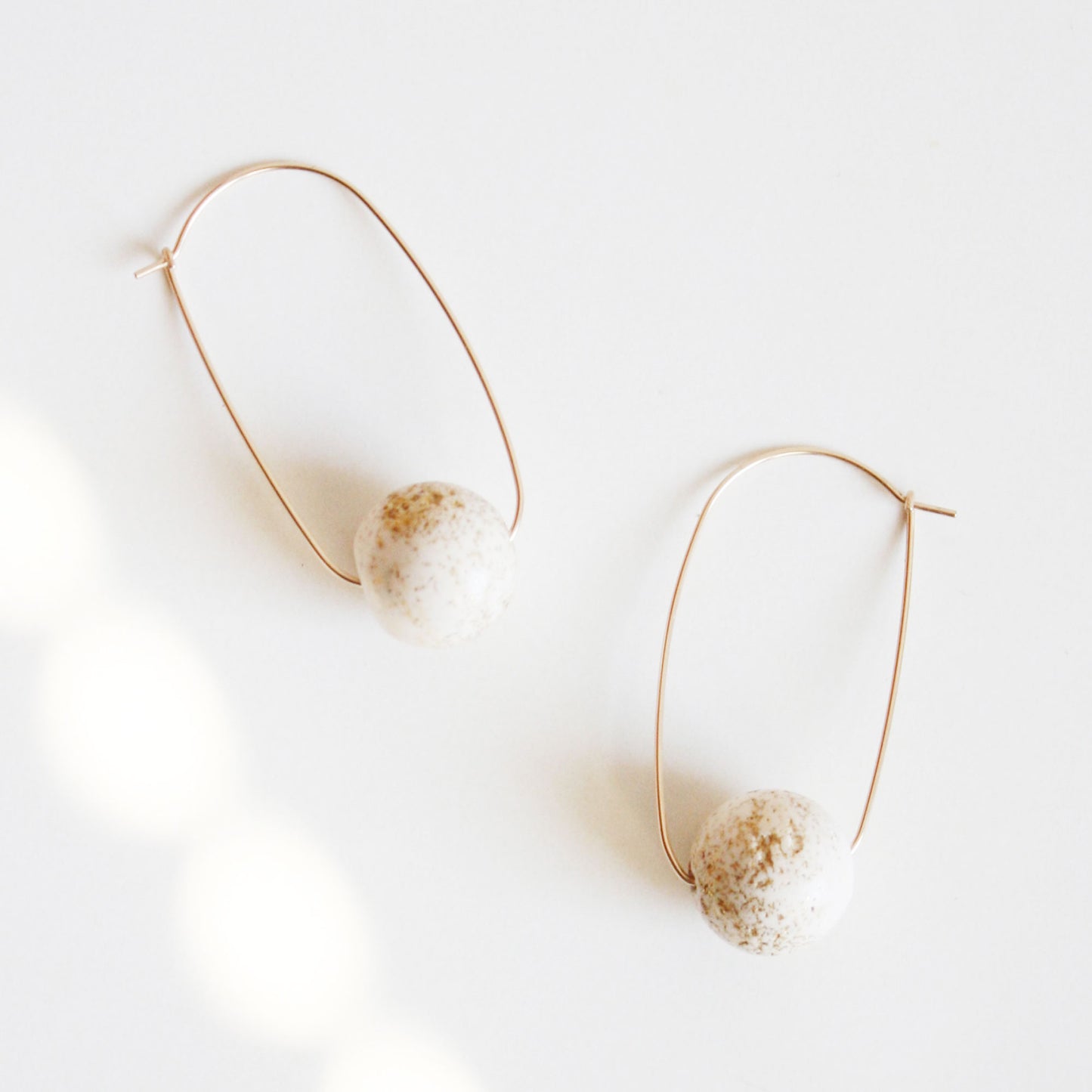 Oval Hoop Earrings with Large White Balls